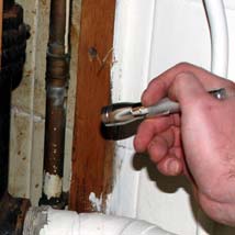 Specific Asbestos Sampling Asbestos surveyor inspecting a pipe
