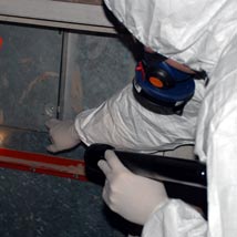 Asbestos refurbishment survey Asbestos surveyor inspecting a wall