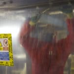 When is asbestos reportable under RIDDOR?