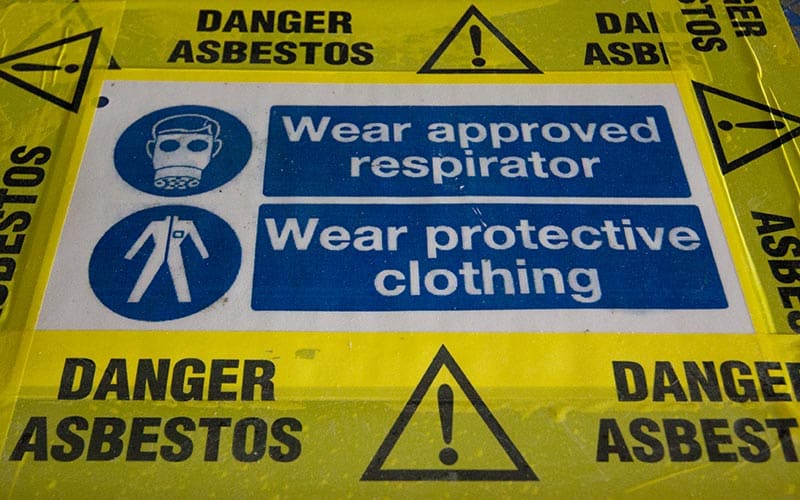 When was asbestos banned in the UK?