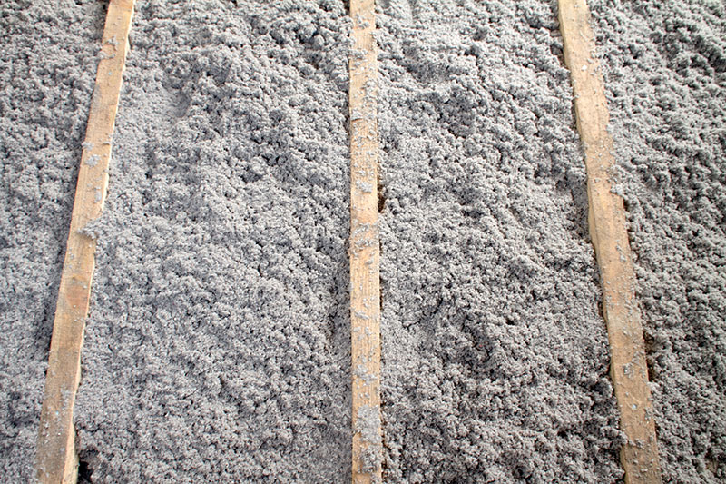 What cellulose insulation looks like – shredded grey paper, loose-fill texture