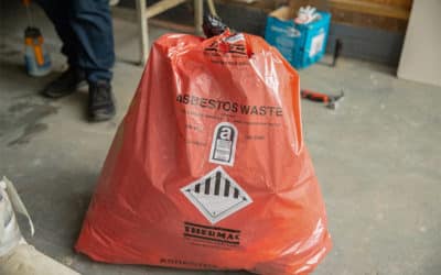 How do I safely manage or remove asbestos in a building?